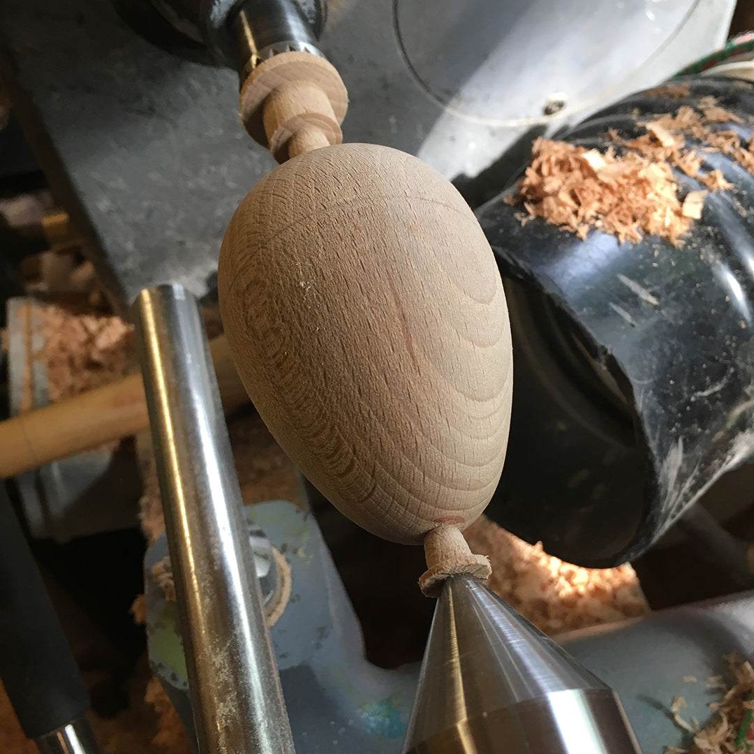 Hand-turned wooden darning egg on wood lathe